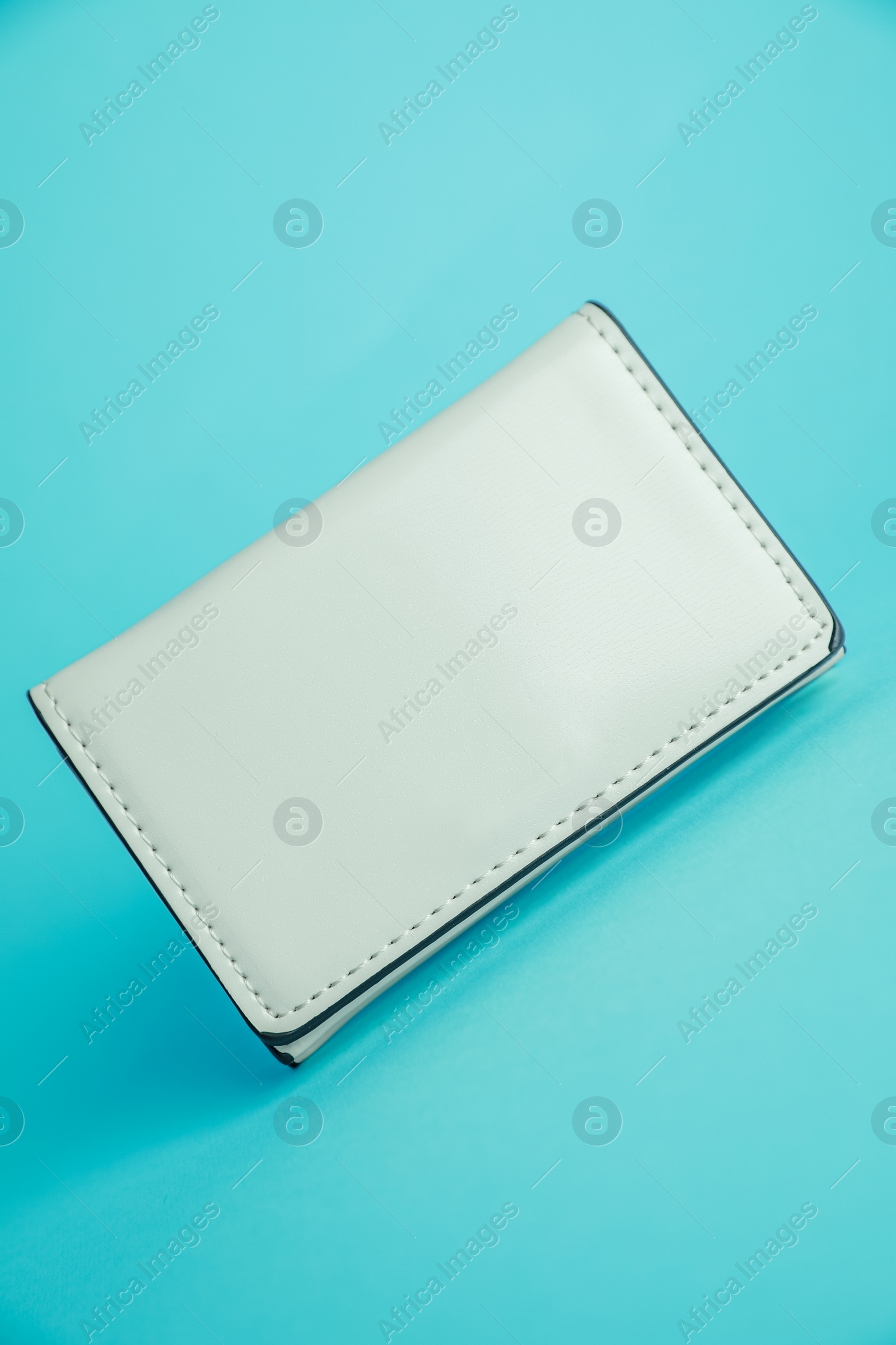 Photo of Stylish leather purse on light blue background