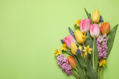 Beautiful bouquet of different flowers on green background, flat lay. Space for text