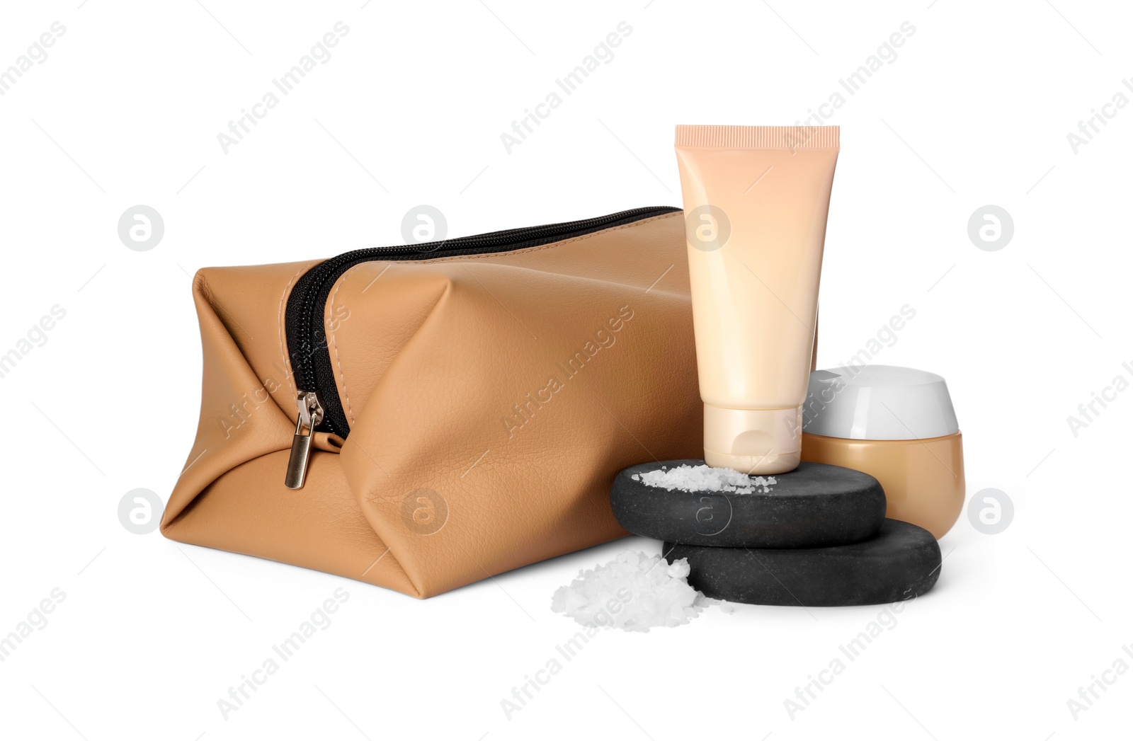 Photo of Compact toiletry bag, spa stones and different cosmetic products isolated on white