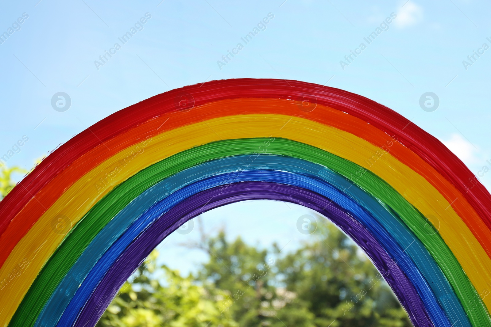 Photo of Painting of rainbow on window, closeup. Stay at home concept