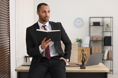 Photo of Portrait of serious lawyer with book in office, space for text