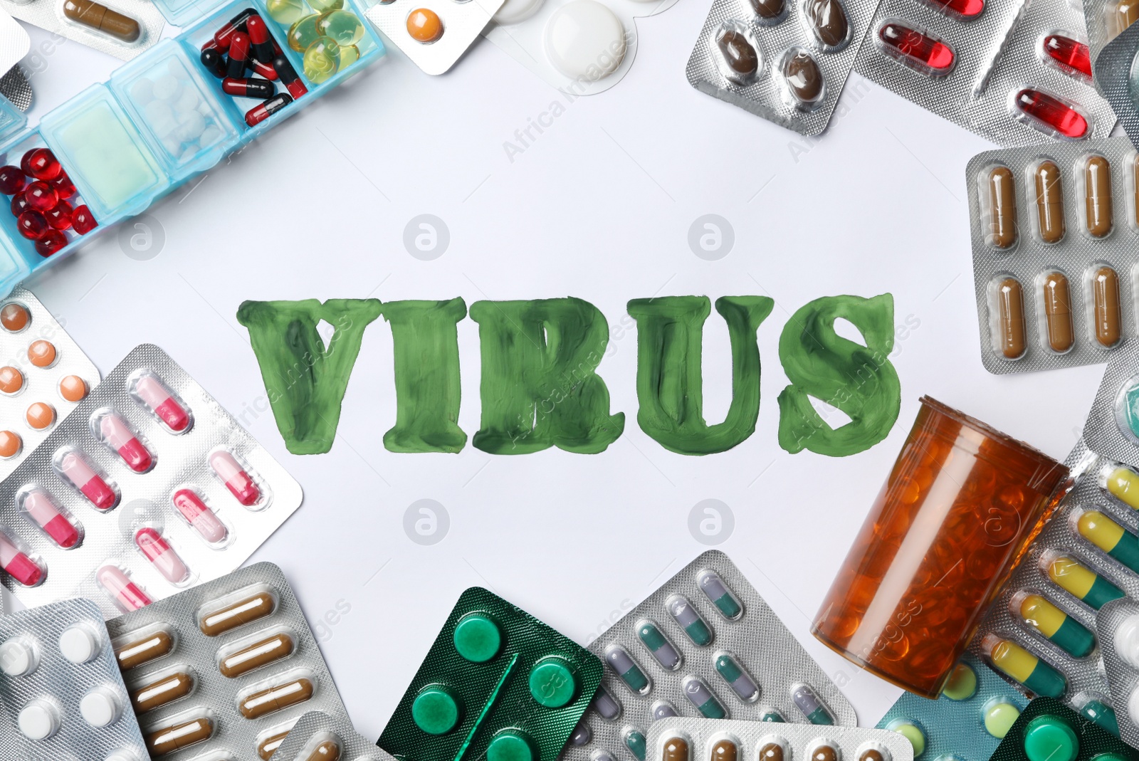 Photo of Word VIRUS and many different pills on white background, flat lay