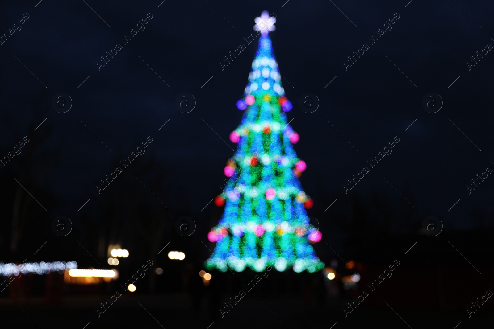 Photo of Beautiful decorated Christmas tree outdoors. Bokeh effect