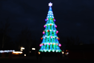 Beautiful decorated Christmas tree outdoors. Bokeh effect