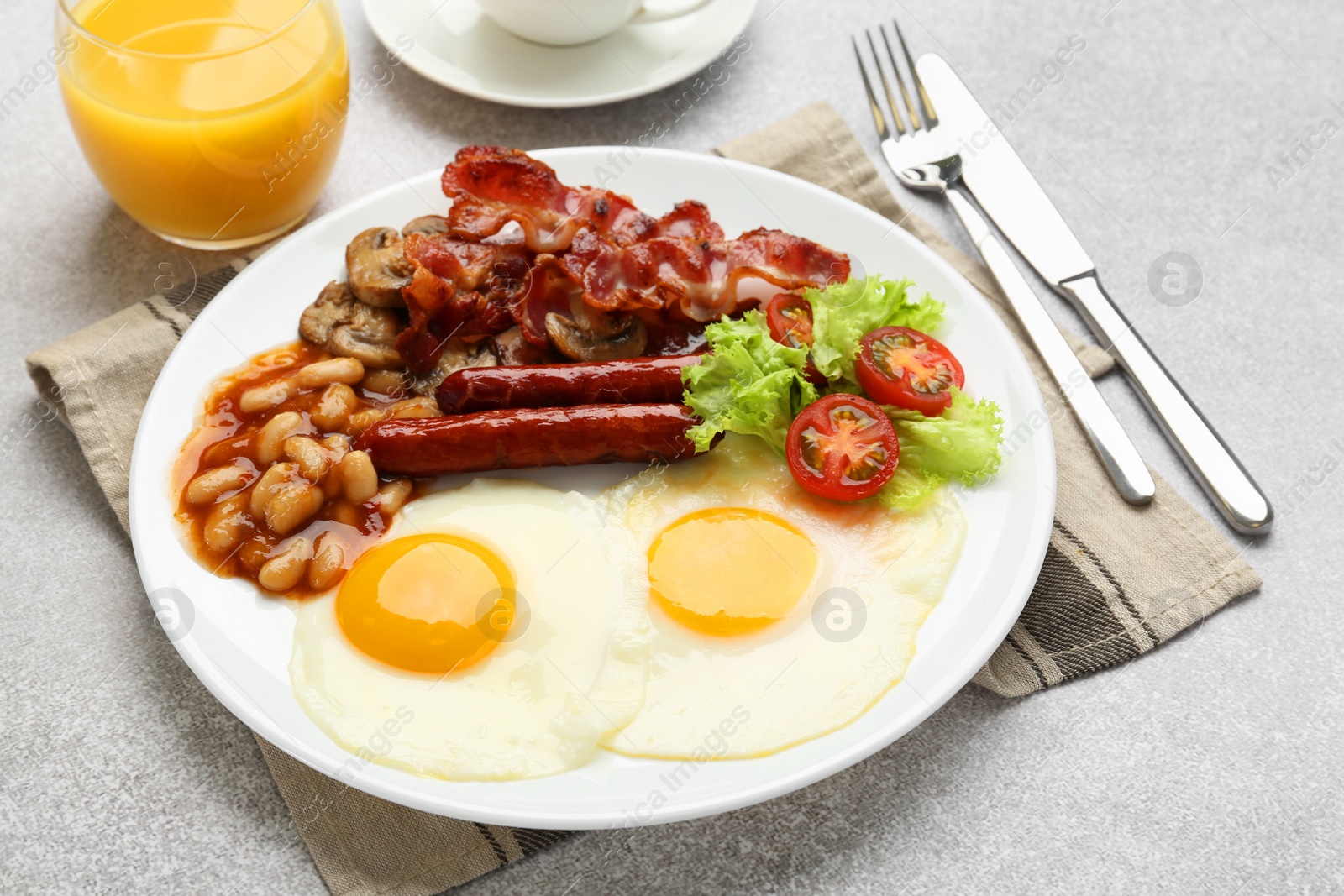 Photo of Delicious breakfast with sunny side up eggs on light table