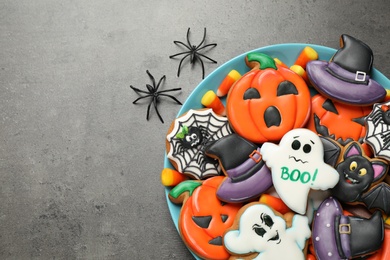 Tasty cookies and sweets for Halloween party on black table, flat lay. Space for text