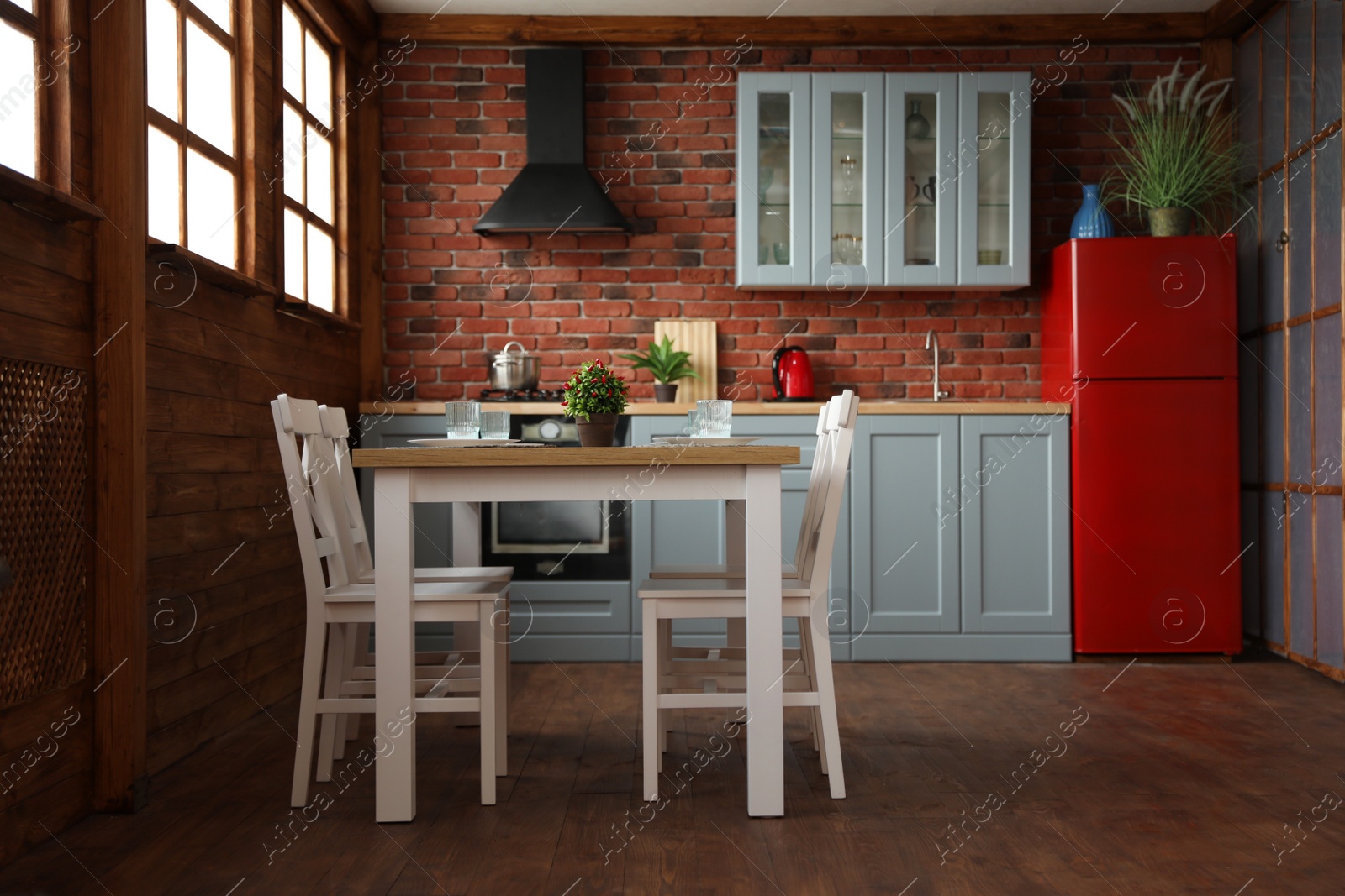 Photo of Stylish kitchen interior with dining table and chairs