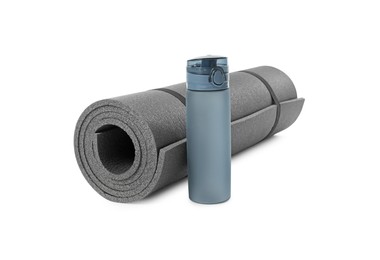 Grey yoga mat and bottle of water isolated on white