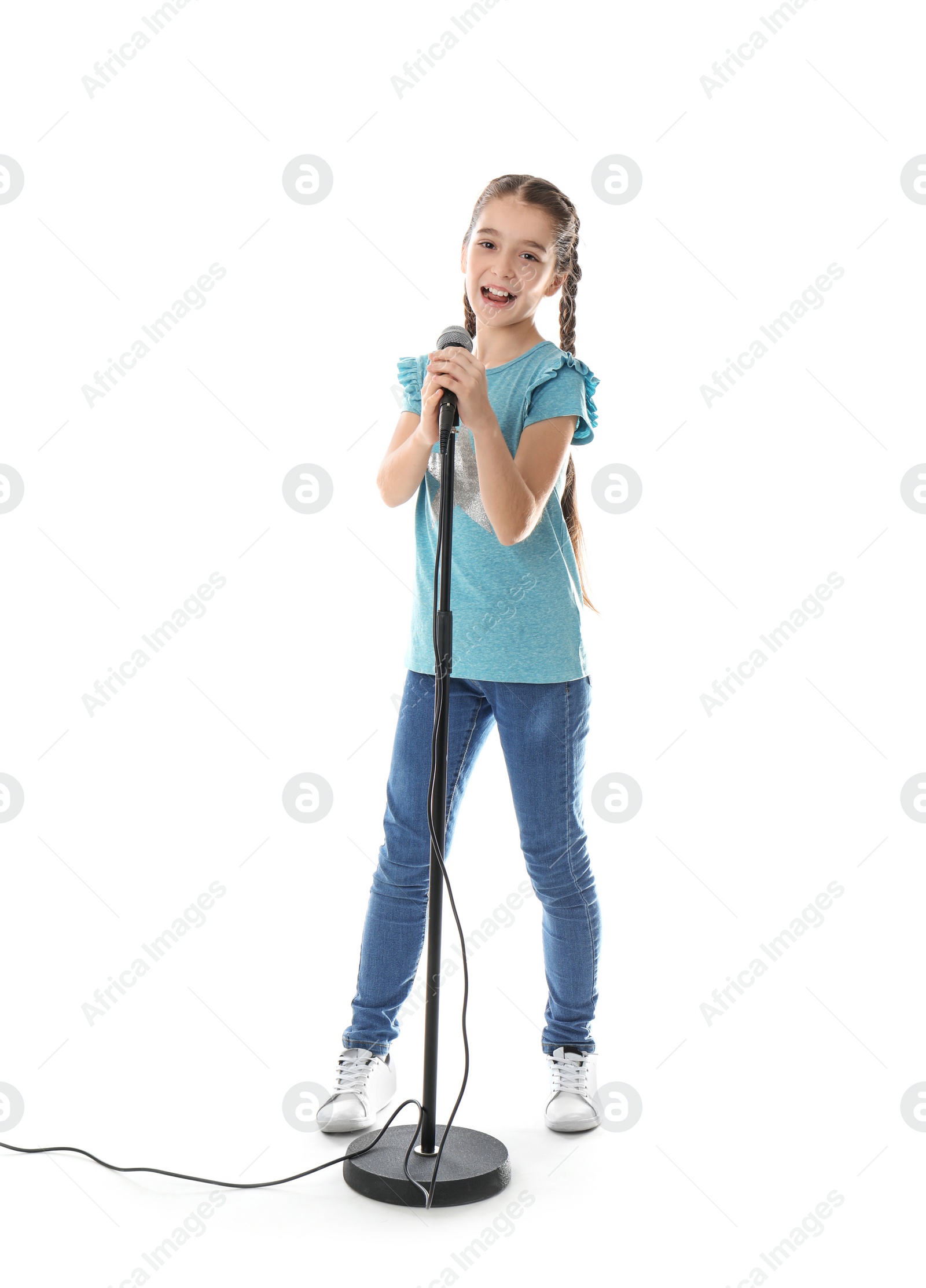 Photo of Cute girl singing in microphone on white background