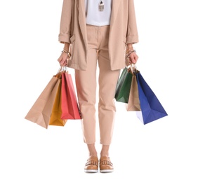 Young woman with shopping bags on white background, closeup