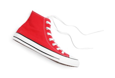 Photo of One new red stylish plimsoll on white background, top view