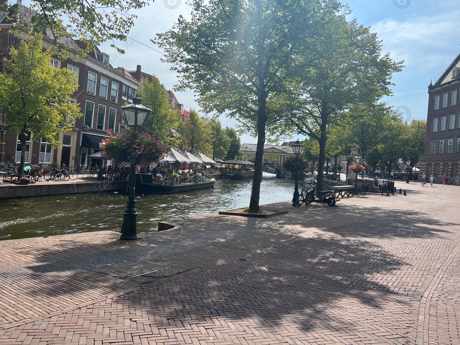 Photo of Beautiful view of buildings, canal and plants outdoors on sunny day