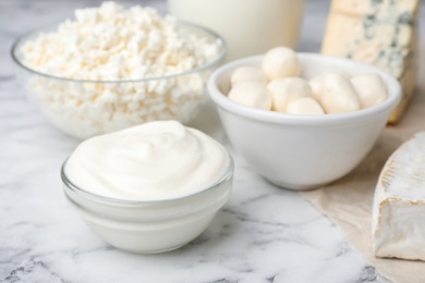 Photo of Sour cream and other dairy products on table, closeup