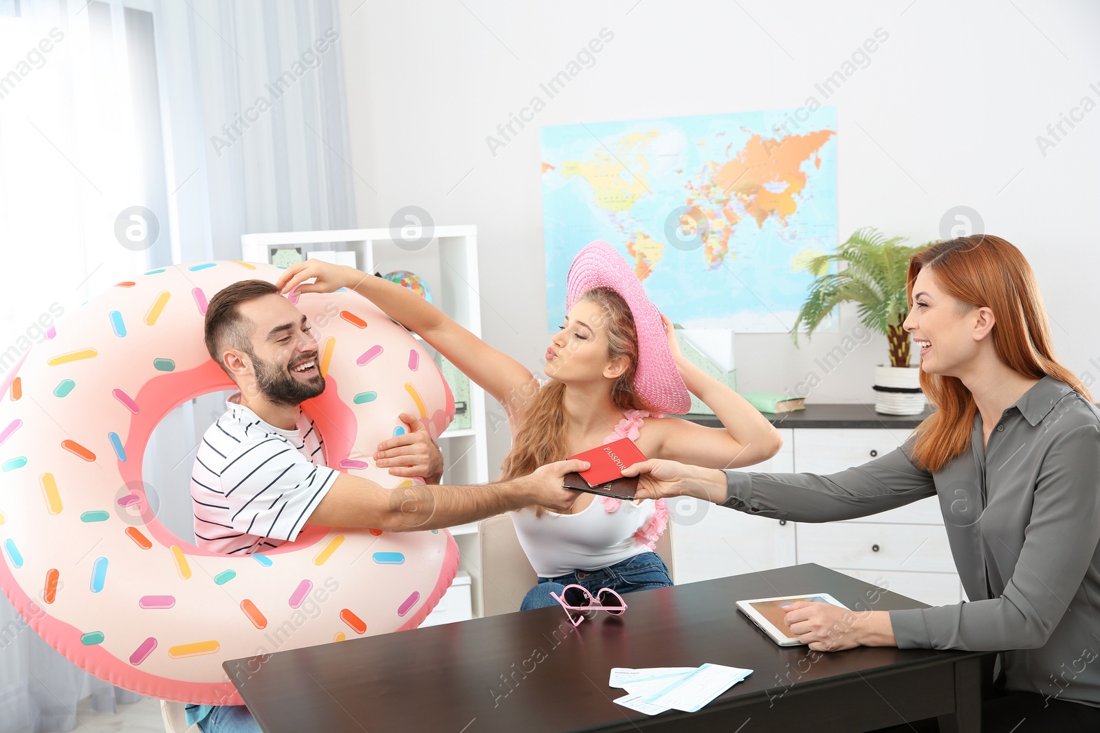 Photo of Beautiful young couple visiting travel agency office