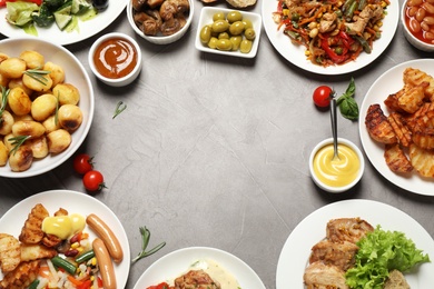 Photo of Buffet service. Frame of different dishes on grey table, space for text