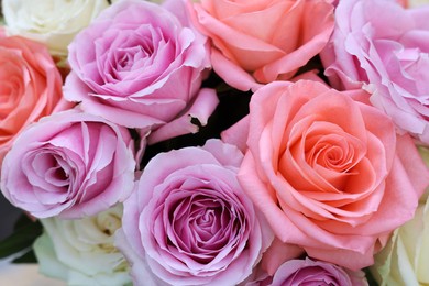 Photo of Beautiful bouquet of aromatic roses as background, closeup