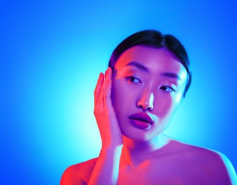 Image of Portrait of beautiful Asian woman in neon lights