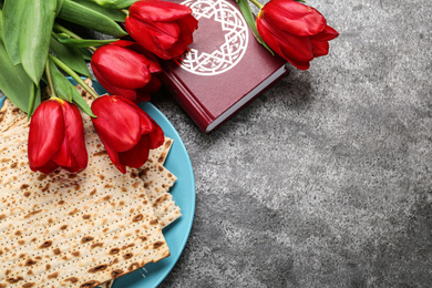 Photo of Flat lay composition with traditional Pesach (Passover Seder) matzo on grey table. Space for text