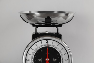 Photo of Retro mechanical kitchen scale on light grey background, closeup