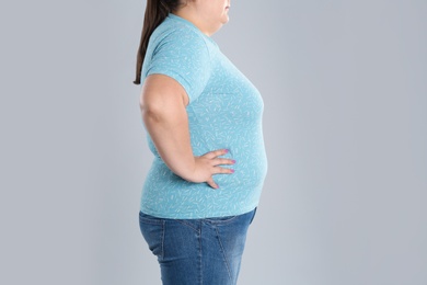 Photo of Overweight woman before weight loss on color background