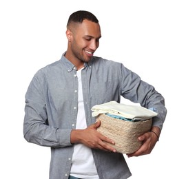 Happy man with basket full of laundry on white background