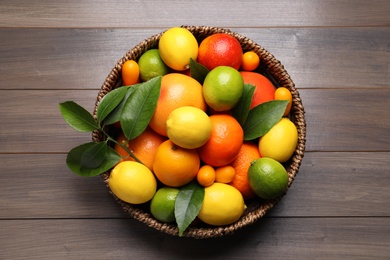 Photo of Different citrus fruits on wooden table, top view