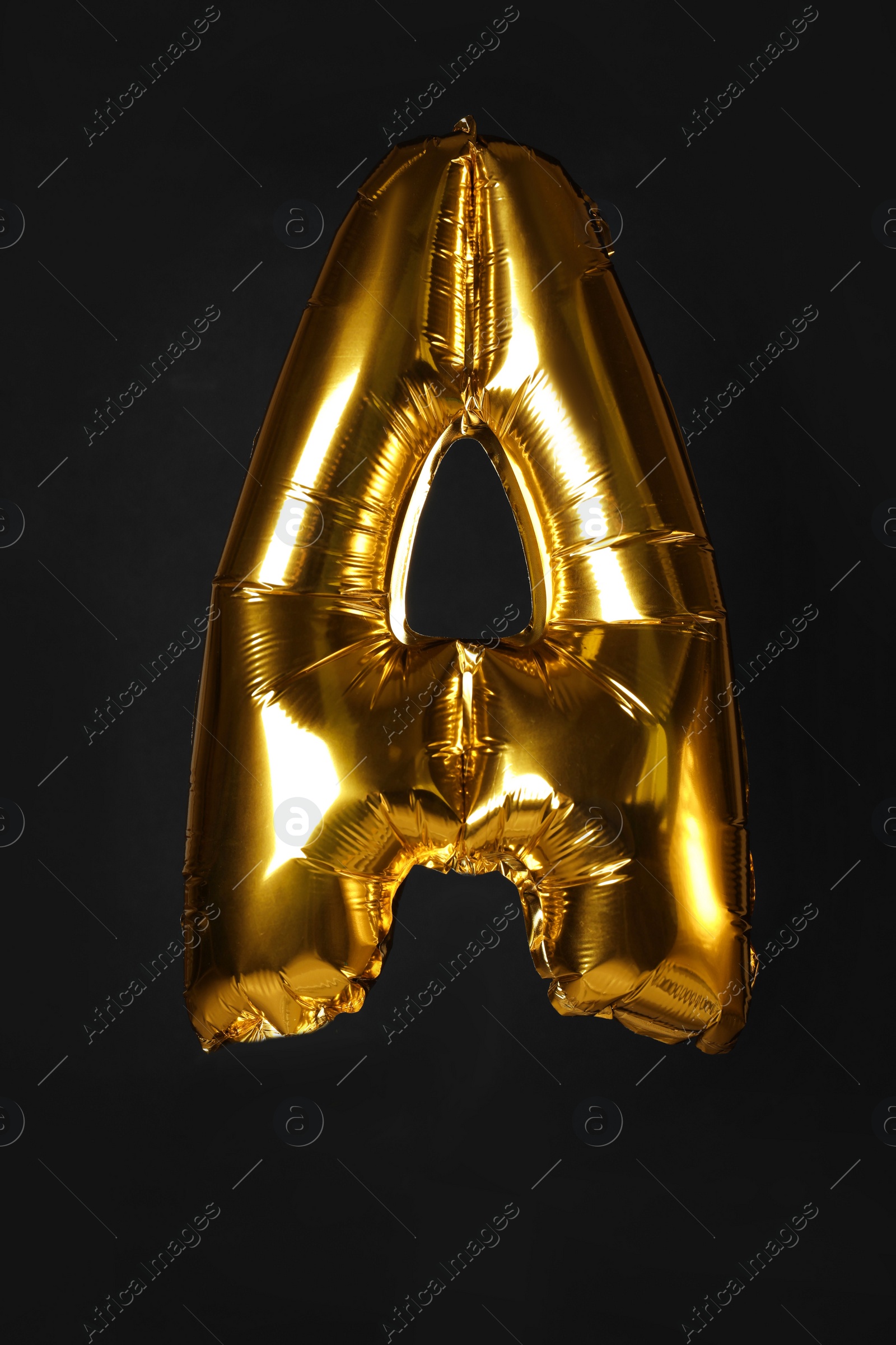 Photo of Golden letter A balloon on black background