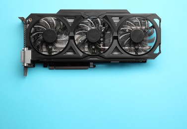 One graphics card on light blue background, top view. Space for text