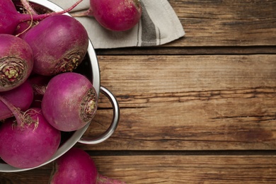 Photo of Red turnips on wooden table, flat lay. Space for text