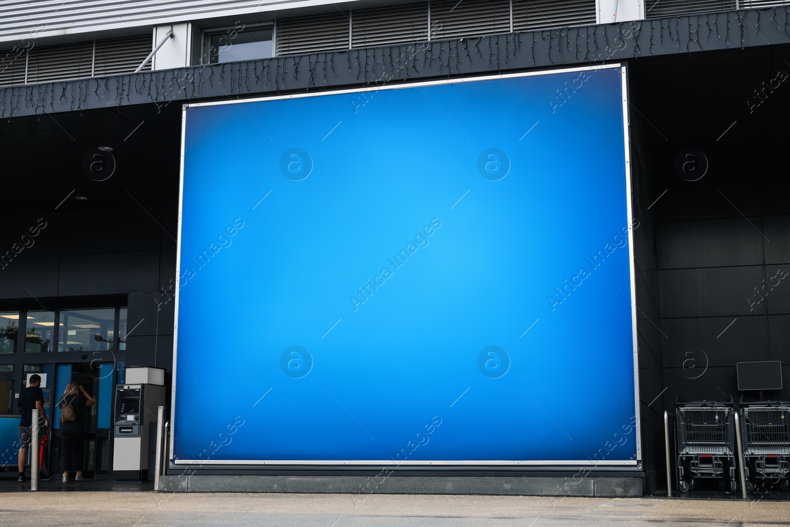 Photo of Big advertising banner on building facade outdoors
