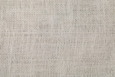 Photo of White burlap fabric as background, top view