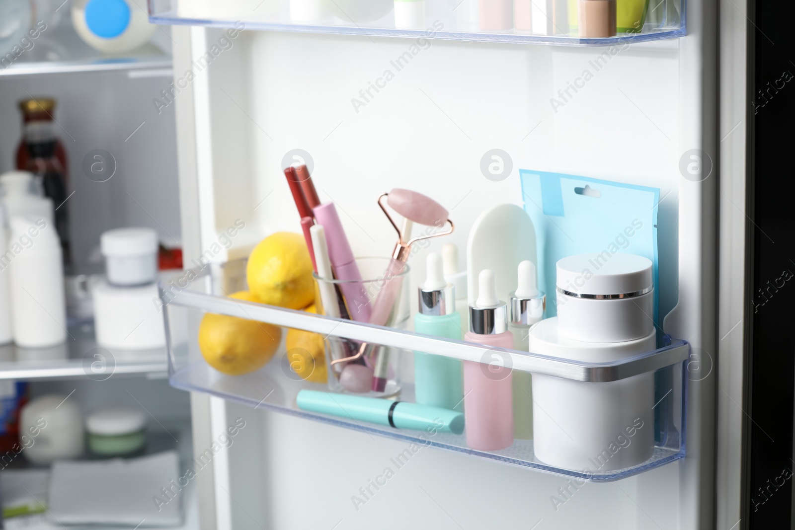 Photo of Different cosmetic products on shelves in refrigerator