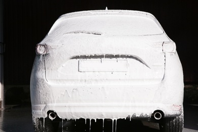 Photo of Automobile covered with foam at car wash