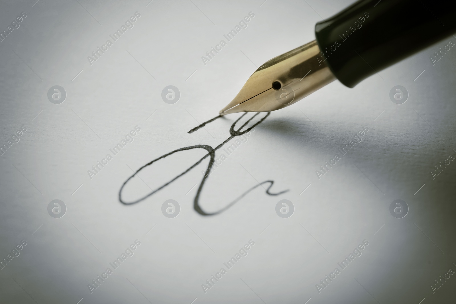 Image of Signing on sheet of paper with fountain pen, closeup