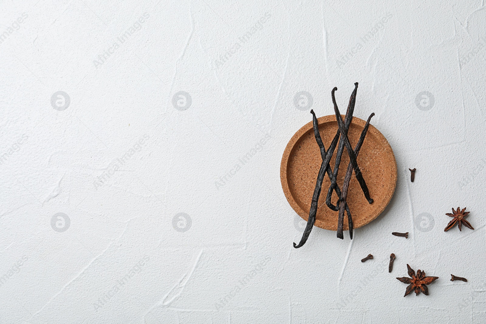 Photo of Plate with aromatic vanilla sticks on white background