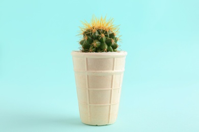 Photo of Cactus in ice cream waffle on cyan background. Tooth sensitivity to cold