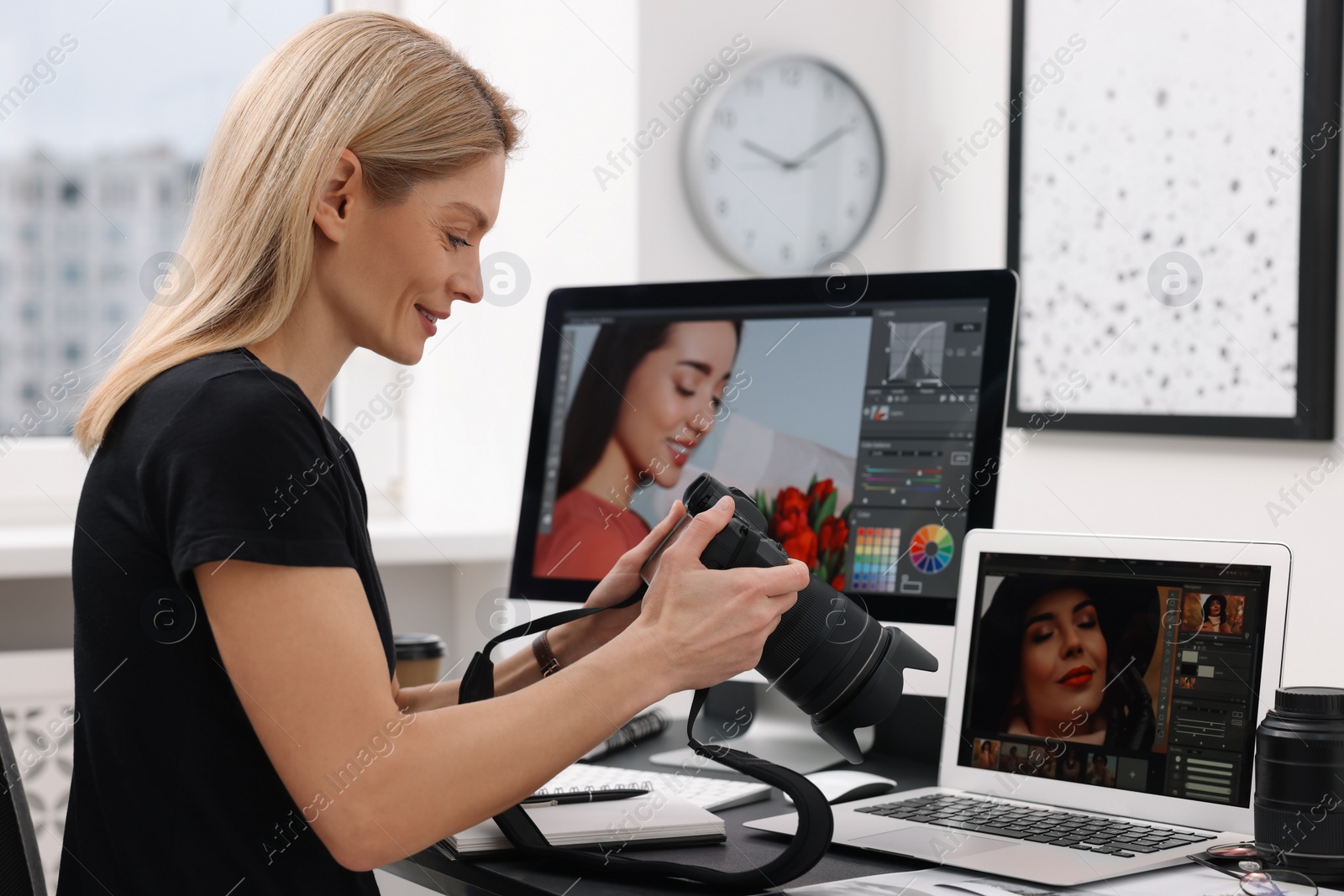 Photo of Professional photographer with digital camera at table in office