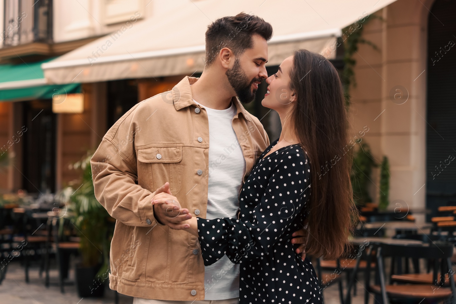 Photo of Lovely couple dancing together on city street