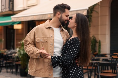 Lovely couple dancing together on city street