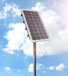 Modern solar panel and blue cloudy sky on background. Alternative energy source