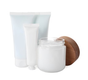 Photo of Jar and tubes of hand cream on white background