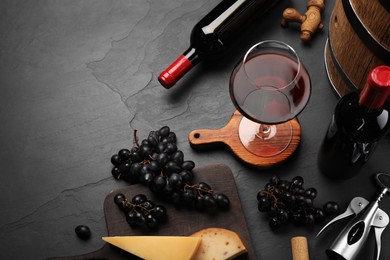 Photo of Winemaking. Composition with tasty wine and wooden barrel on gray table, above view. Space for text