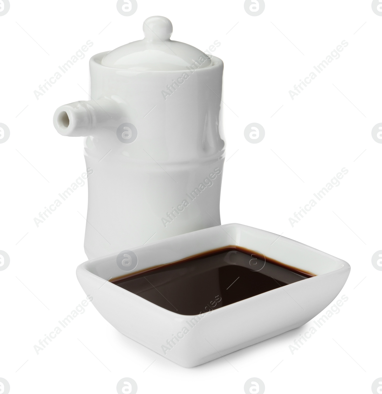 Photo of Tableware with soy sauce on white background