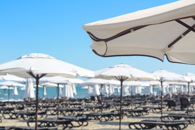 Photo of Beautiful white beach umbrella at resort, closeup. Space for text