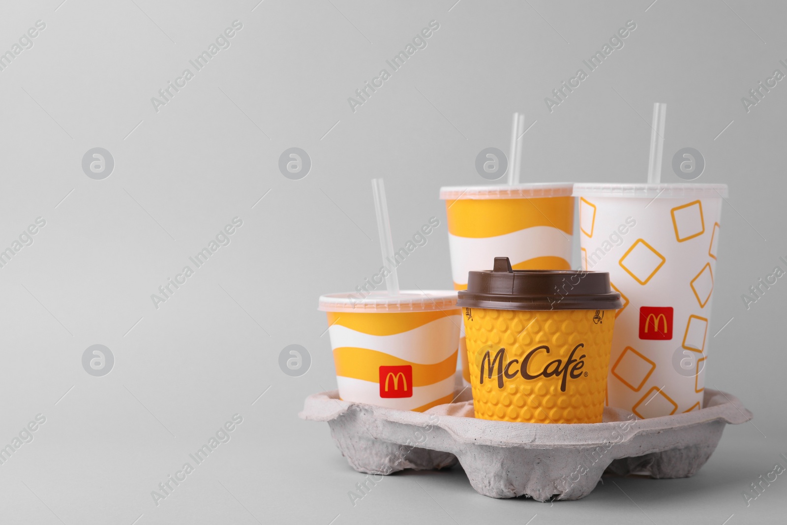 Photo of MYKOLAIV, UKRAINE - AUGUST 12, 2021: Cold and hot McDonald's drinks on light background. Space for text