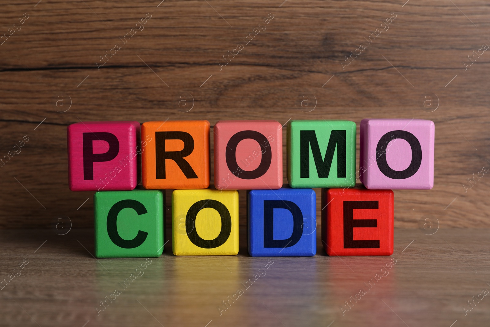 Photo of Words Promo Code made of colorful cubes with letters on wooden table