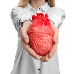 Photo of Woman holding model of heart on white background. Heart attack concept