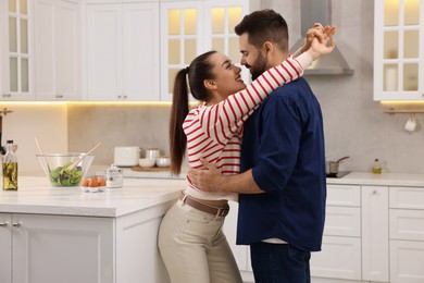 Photo of Lovely couple enjoying time together in kitchen