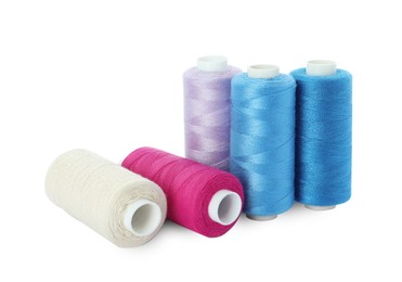 Photo of Many different colorful sewing threads on white background