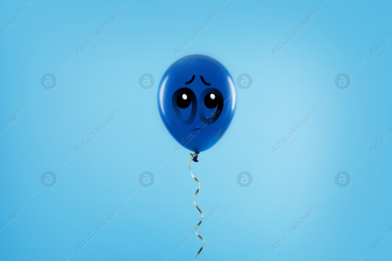 Image of Blue balloon with sad face on light blue background